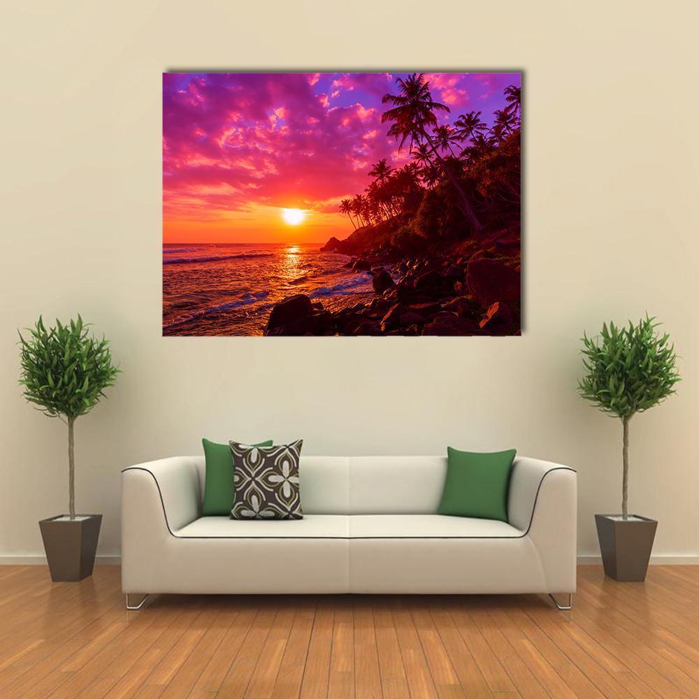 Tropical Sunset with Palm Trees Canvas Wall Art in orange, purple and pink, single panel hung on a wall