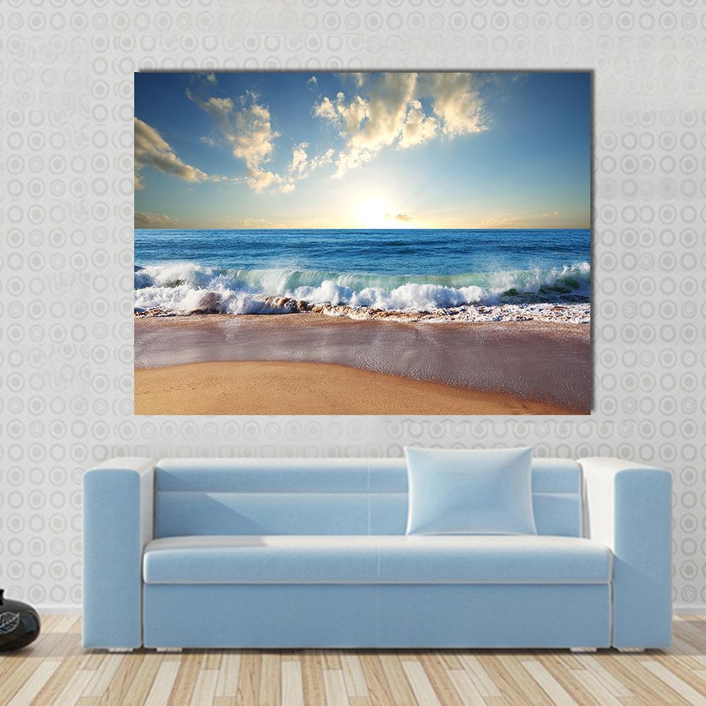 Sunset on Beach with Strong Ocean Waves Canvas Wall Art in beige, yellow and blue, single panel hung on a wall