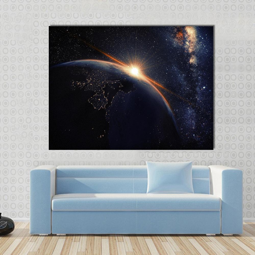 Sunset on Planet Earth at Night Canvas Wall Art in black, orange and blue, single panel hung on a wall