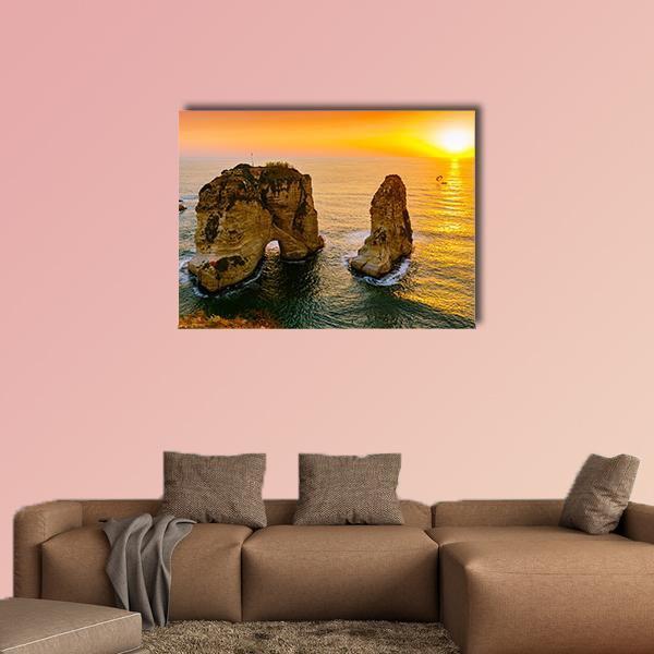 Sunset Over Sea Stacks Canvas Wall Art in orange, yellow and blue, single panel hung on a wall