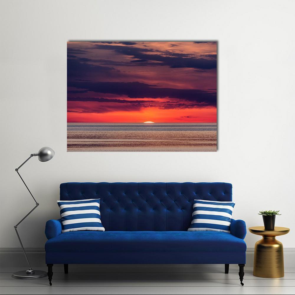 Sunset Over Ocean with Horizon Cloud Band Canvas Wall Art in orange, blue and purple, single panel hung on a wall