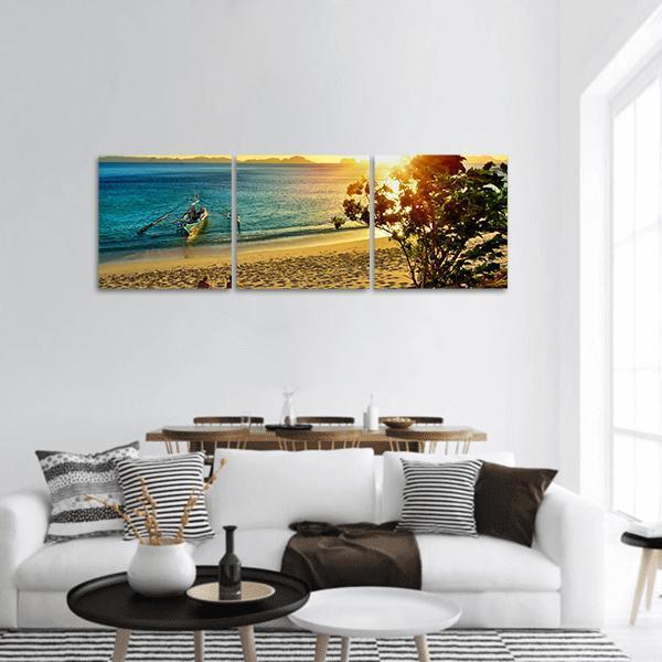 El Nido Sunset Beach Panoramic Canvas Wall Art in orange, yellow and blue, hung on a wall