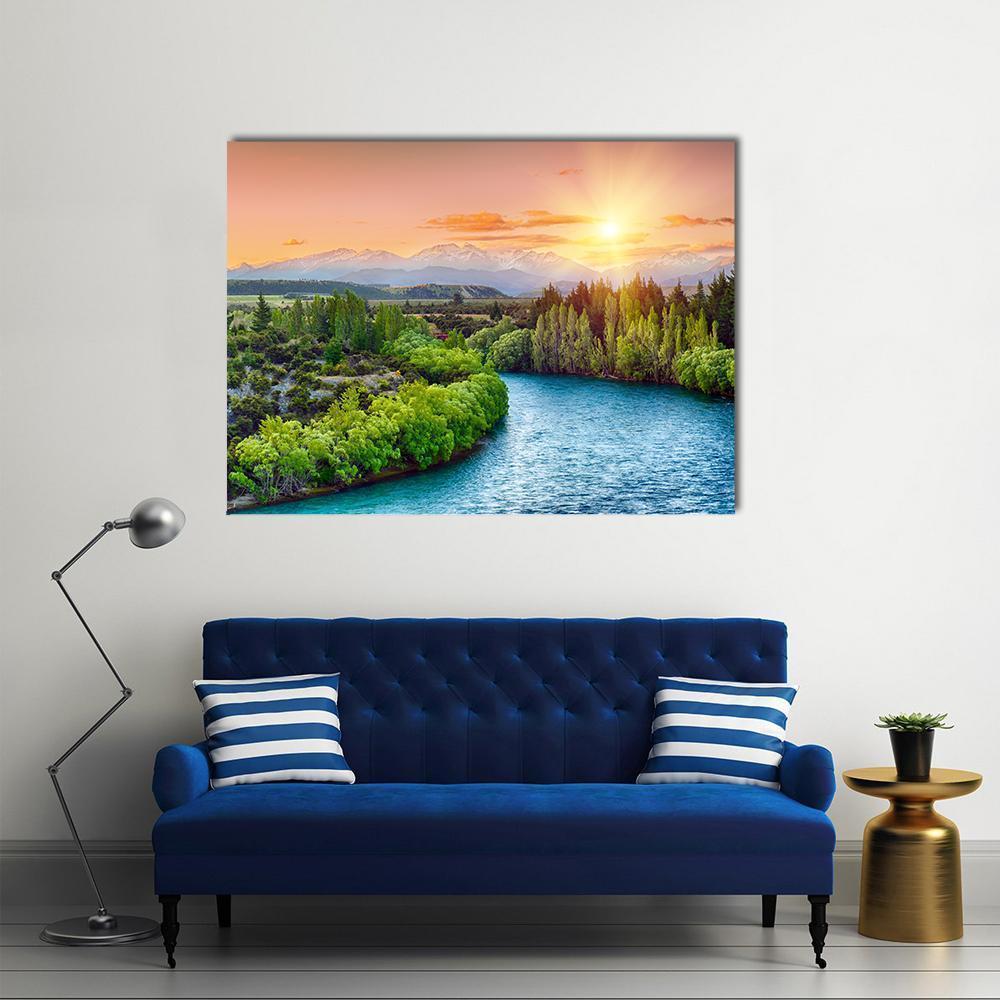 Golden Sunset Over Winding River Bend Canvas Wall Art in orange, green and blue, single panel hung on a wall