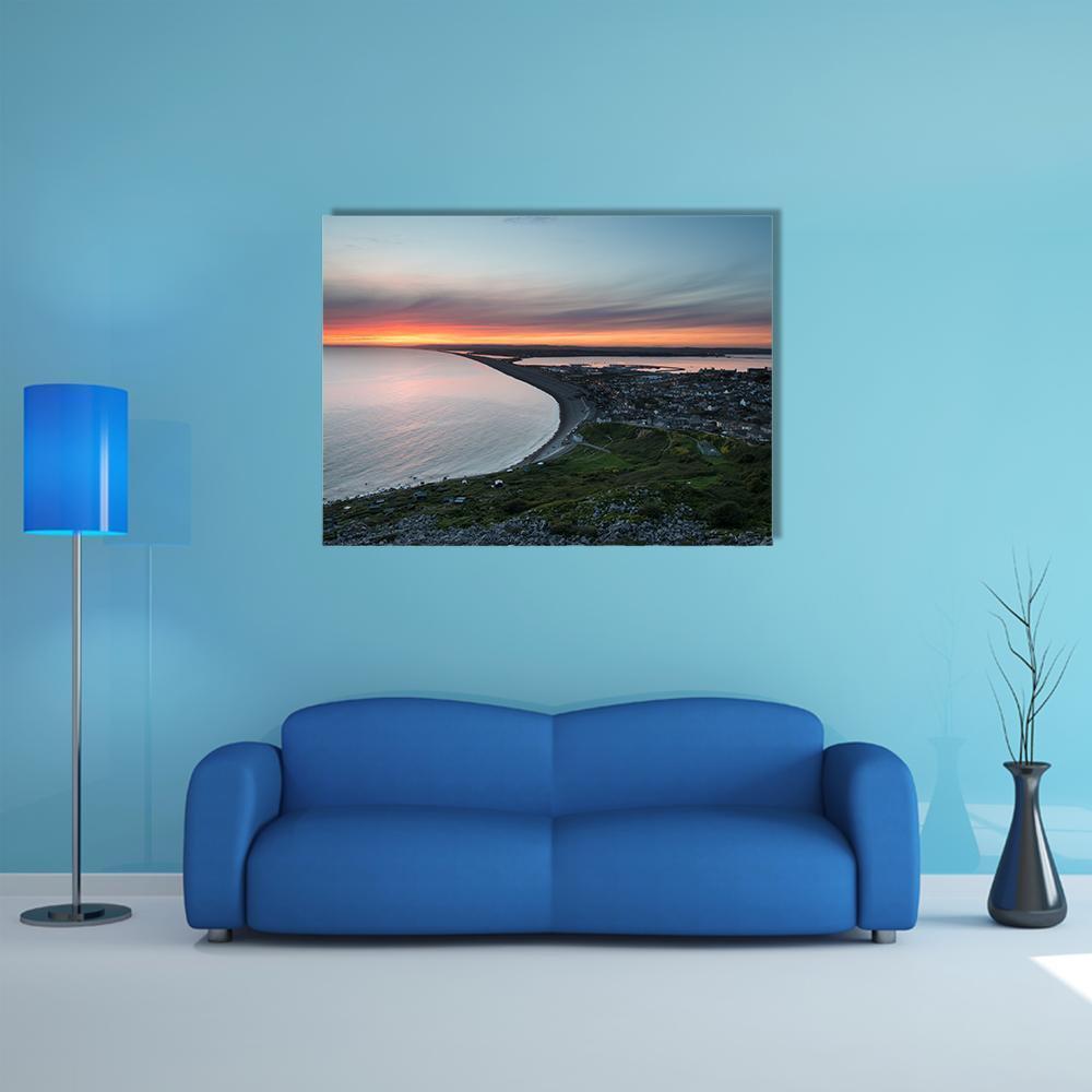 Sunset Over Chesil Beach Canvas Wall Art in gray, orange and blue, single panel hung on a wall