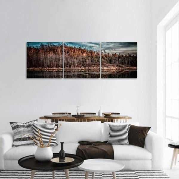 Autumn Sunset Over Forest Lake Panoramic Canvas Wall Art in brown, orange and blue, hung on a wall