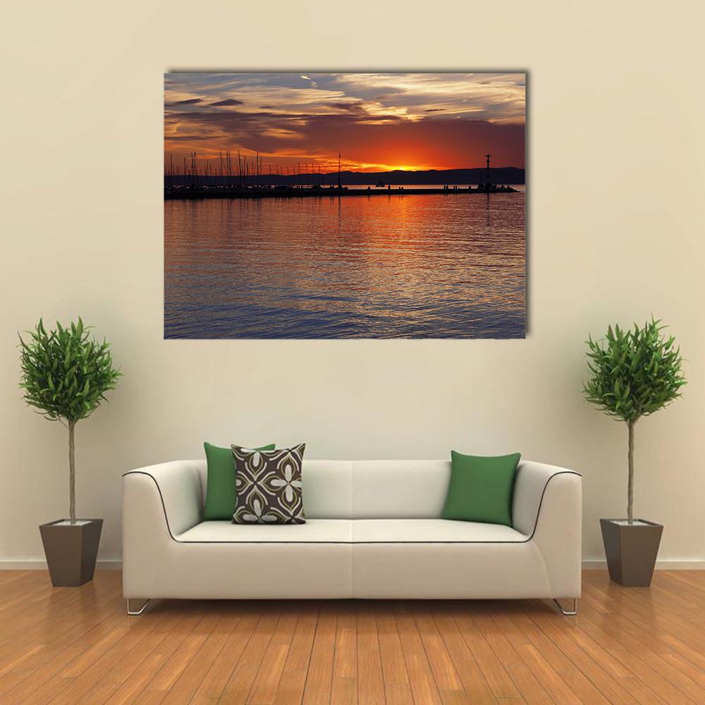 Sunset Over Lake Balaton Canvas Wall Art in orange, yellow and blue, single panel hung on a wall