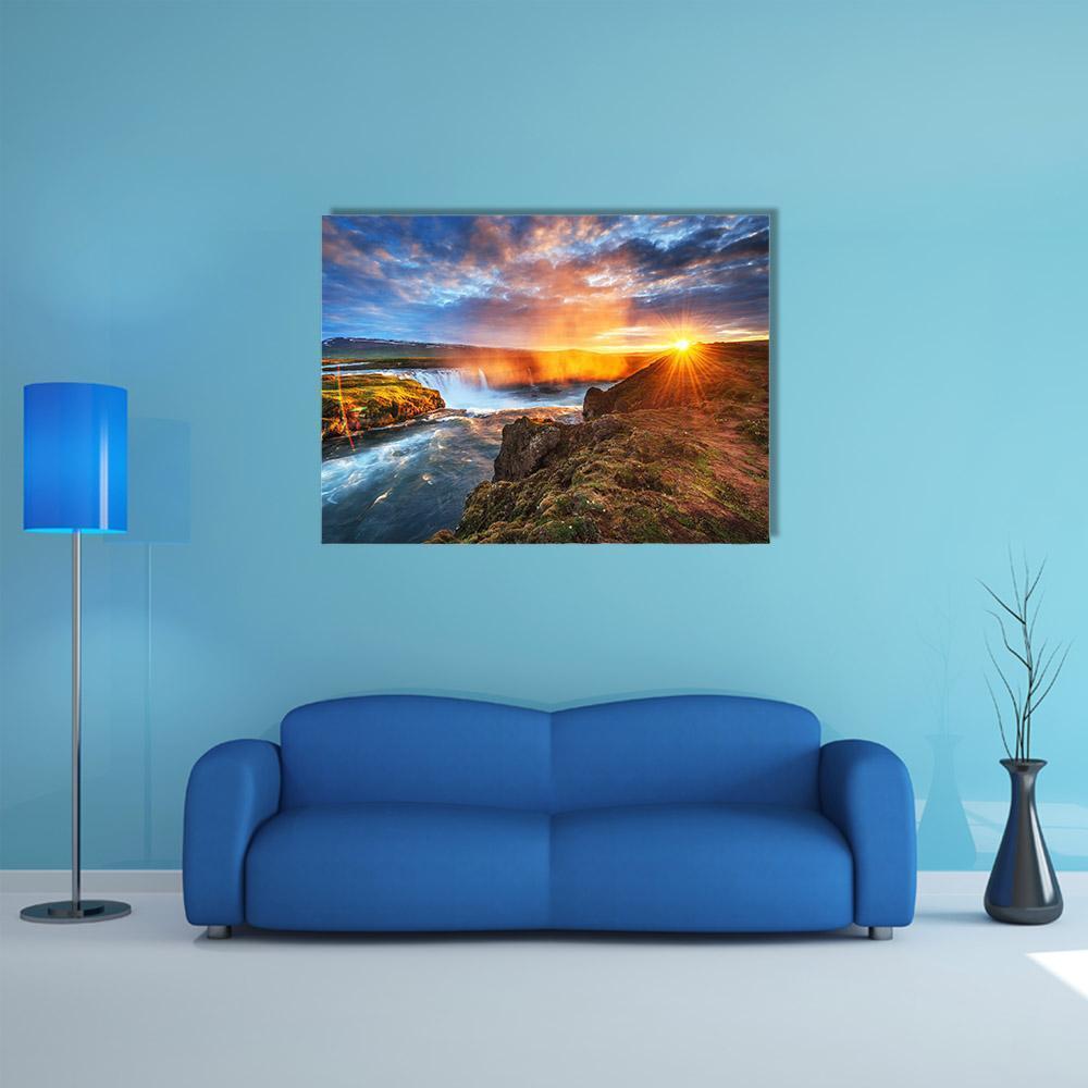 Sunset Over Waterfall and Cliffs Canvas Wall Art in brown, orange and blue, single panel hung on a wall