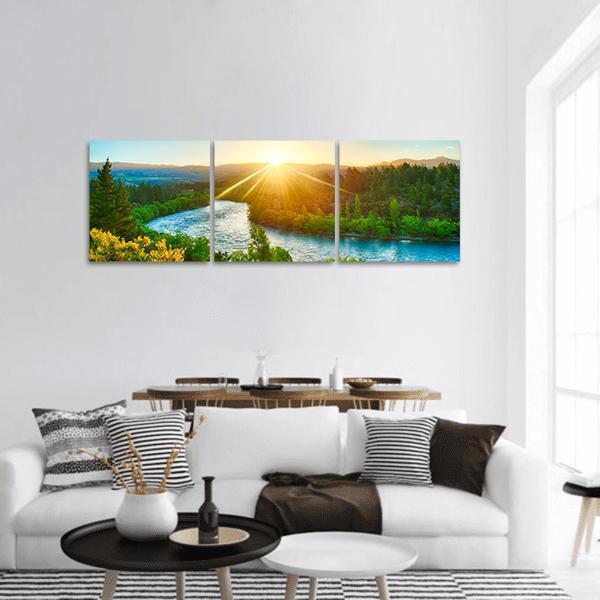 Sunset Over River Clutha Panoramic Canvas Wall Art in yellow, green and blue, hung on a wall