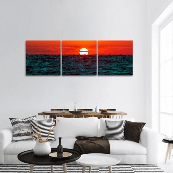 Sunset Over the Baltic Sea, Latvia Panoramic Canvas Wall Art in red, orange and blue, hung on a wall