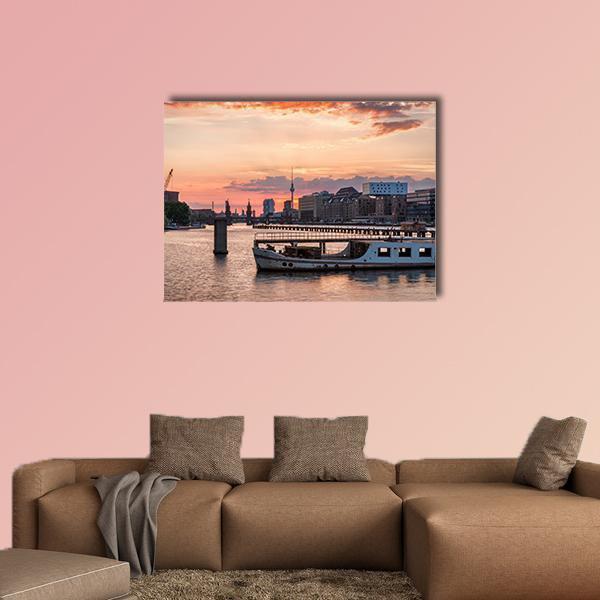 Sunset Over the River Spree Canvas Wall Art in gray, orange and pink, single panel hung on a wall