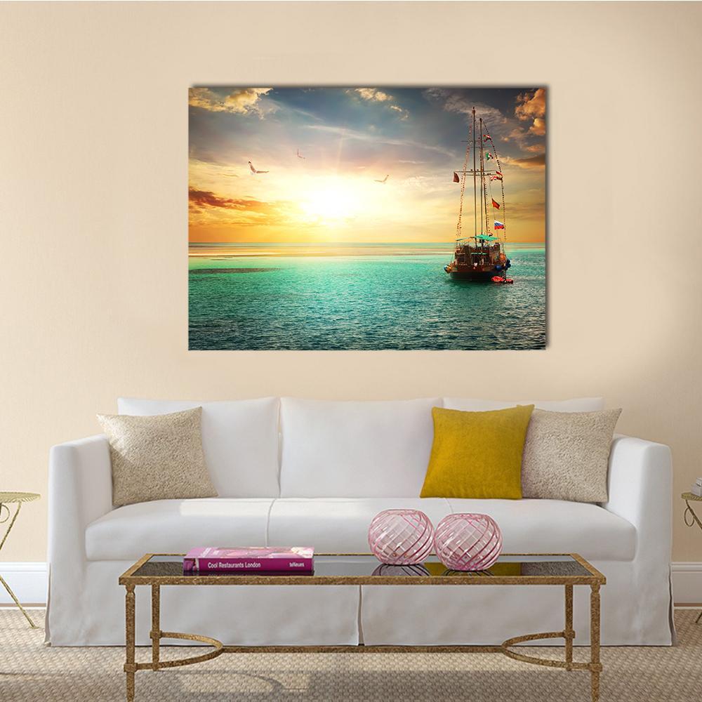 Yacht at Sunset on the Sea Canvas Wall Art in orange, yellow and blue, single panel hung on a wall