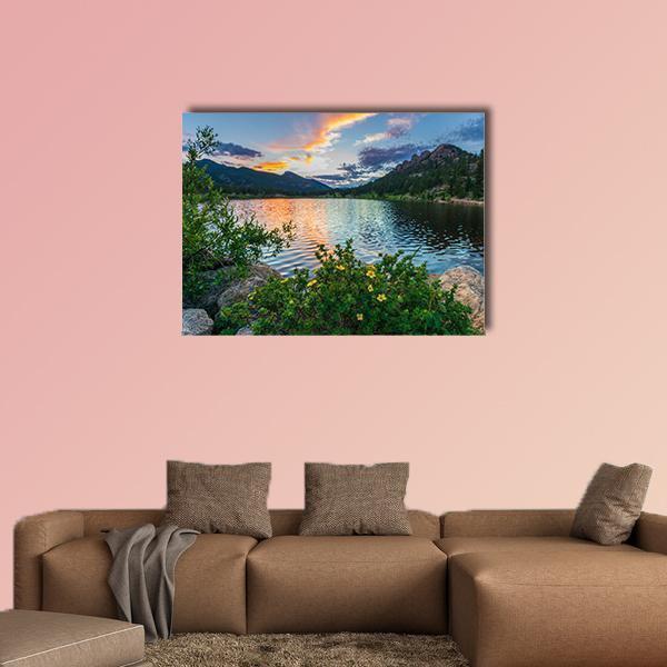 Sunset Over Lily Lake Canvas Wall Art in orange, green and blue, single panel hung on a wall