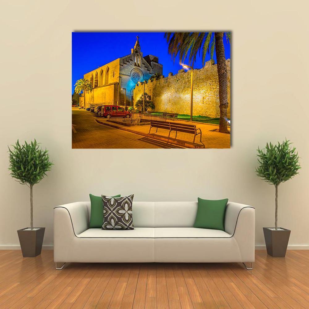 Sunset View of Alcudia Fortification Canvas Wall Art in orange, yellow and blue, single panel hung on a wall