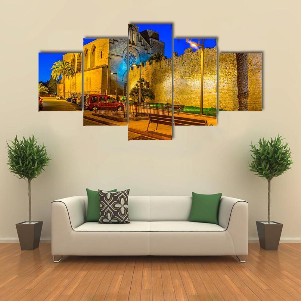 Sunset View of Alcudia Fortification Canvas Wall Art in orange, yellow and blue, 5 panel Star layout hung on a wall