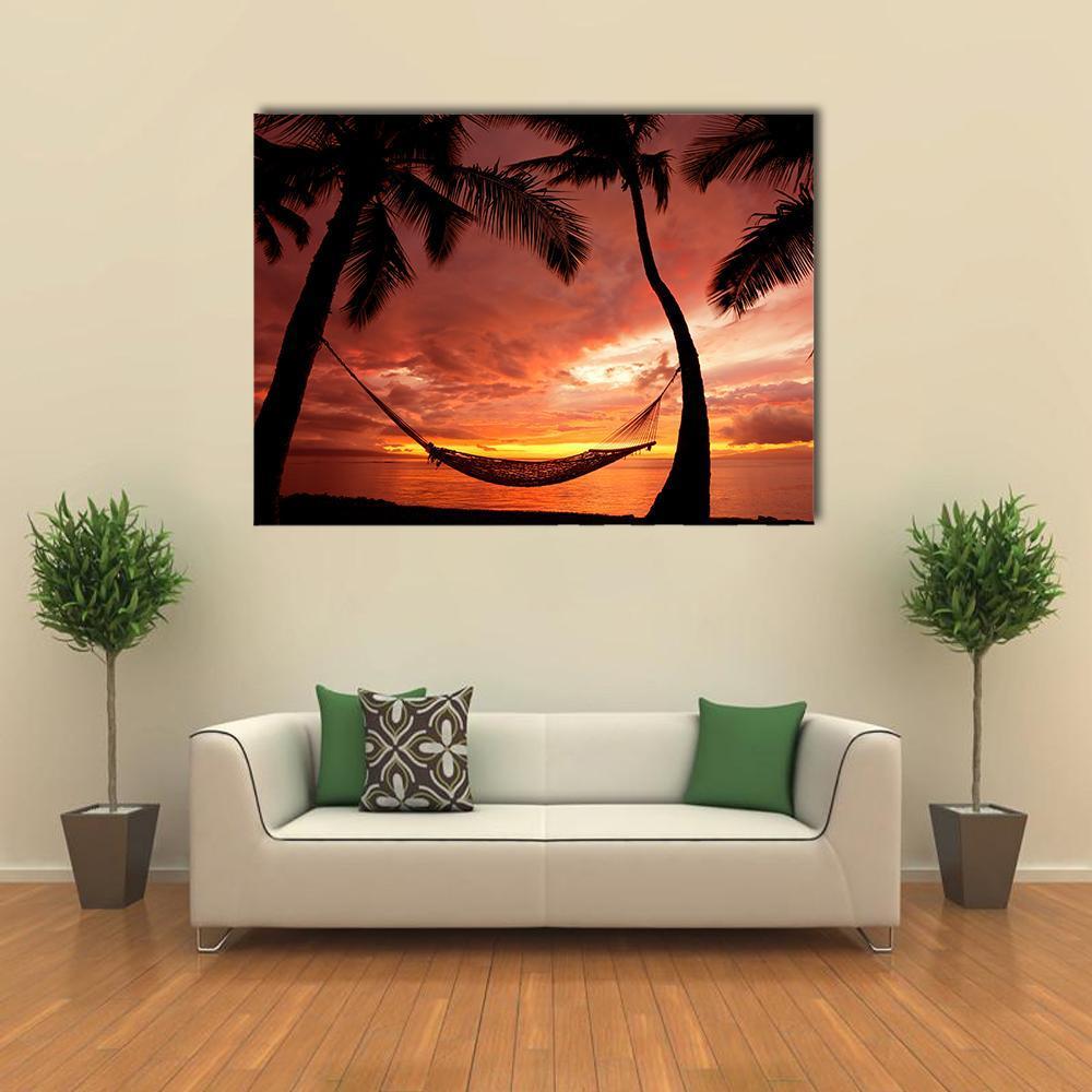 Serene Sunset with Silhouetted Palm Trees Canvas Wall Art in black, red and orange, single panel hung on a wall