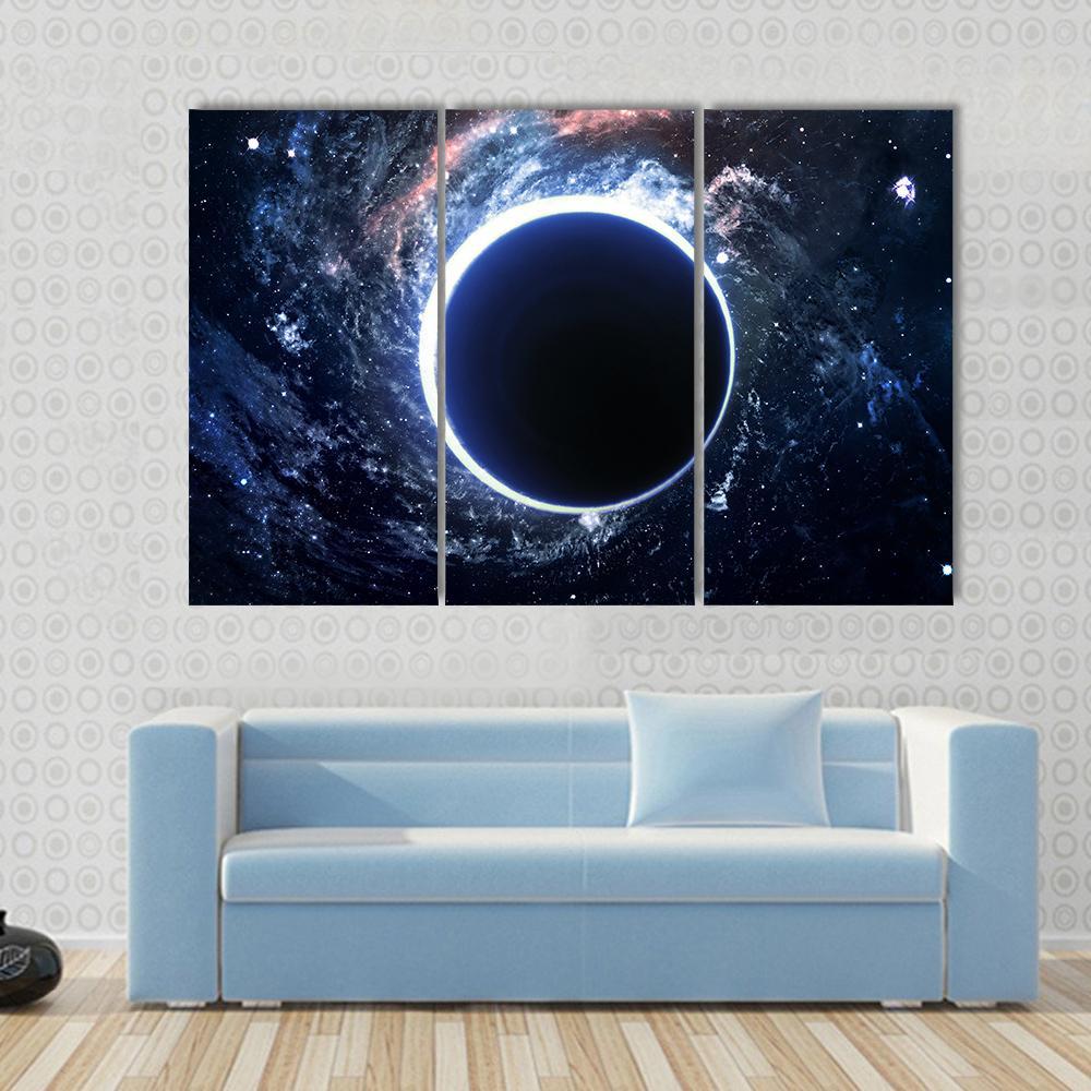 Supermassive Black Hole Canvas Wall Art in black, white and blue, 3 panel horizontal set hung on a wall