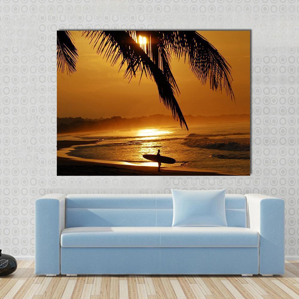 Surfer in Costa Rica Canvas Wall Art in black, orange and yellow, single panel hung on a wall