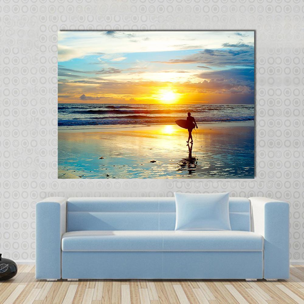 Surfer at Sunset on Bali Beach Canvas Wall Art in orange, yellow and blue, single panel hung on a wall