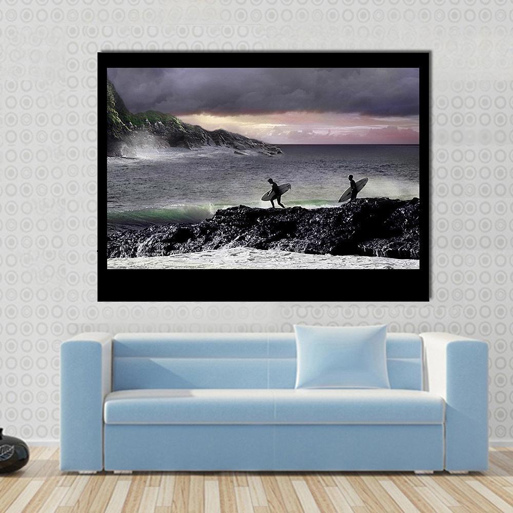 Surfers Walking on Rocks Canvas Wall Art in black, gray and blue, single panel hung on a wall