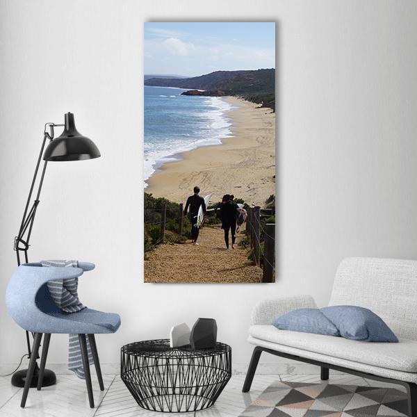 Surfers at Bells Beach Vertical Canvas Wall Art in beige, brown and blue, single vertical panel hung on a wall