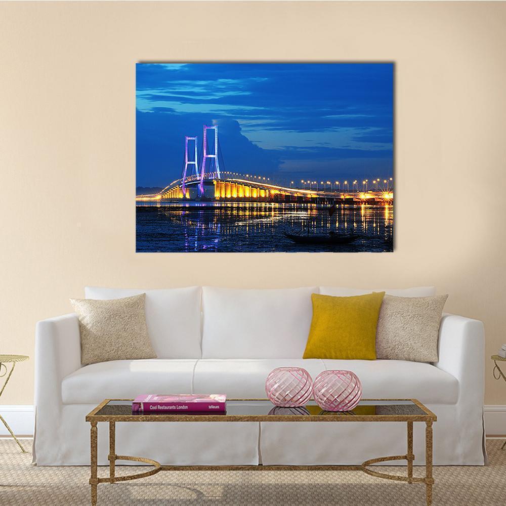 Surmadu Bridge Night Reflection Canvas Wall Art in black, yellow and blue, single panel hung on a wall
