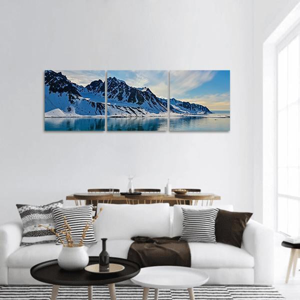 Arctic Fjord with Snow-covered Peaks Panoramic Canvas Wall Art in white and blue, hung on a wall