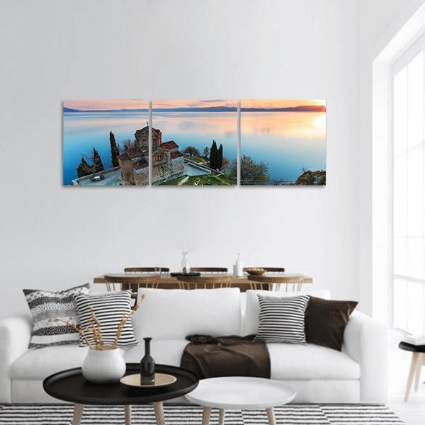 Sveti Jovan Kaneo Church on Lake Ohrid Panoramic Canvas Wall Art in orange, yellow and blue, hung on a wall