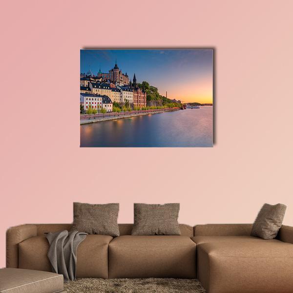 Sweden at Sunset Canvas Wall Art in brown, orange and blue, single panel hung on a wall