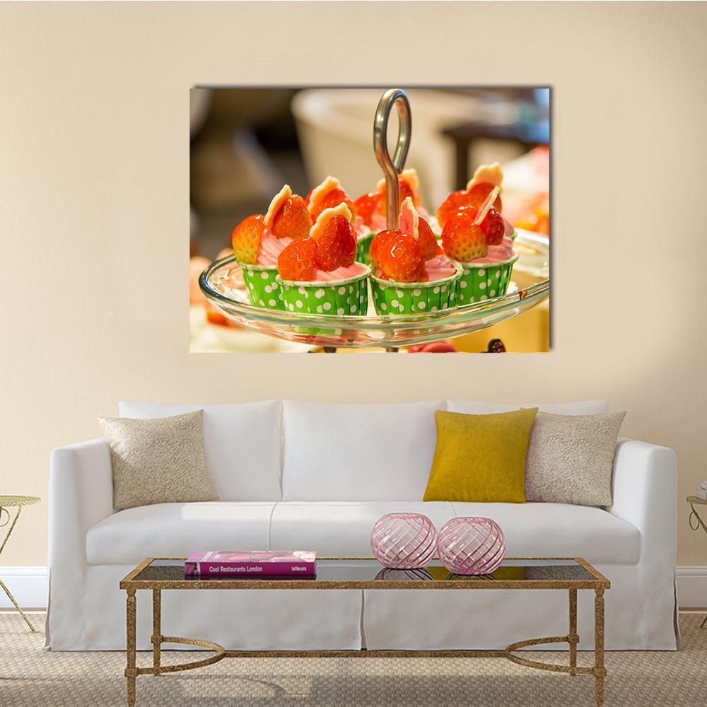 Strawberry Cupcakes with Pink Frosting Canvas Wall Art in red, green and pink, single panel hung on a wall