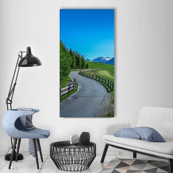 Winding Road in Swiss National Park Vertical Canvas Wall Art in gray, green and blue, single vertical panel hung on a wall