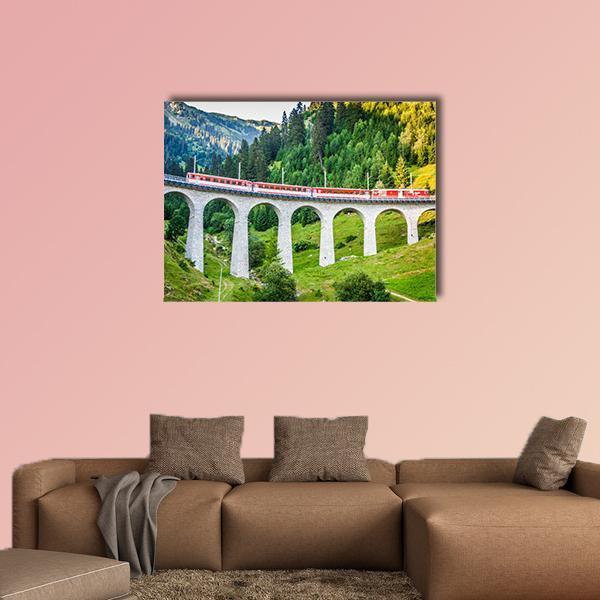 Red Train on Swiss Stone Viaduct Canvas Wall Art in gray, red and green, single panel hung on a wall