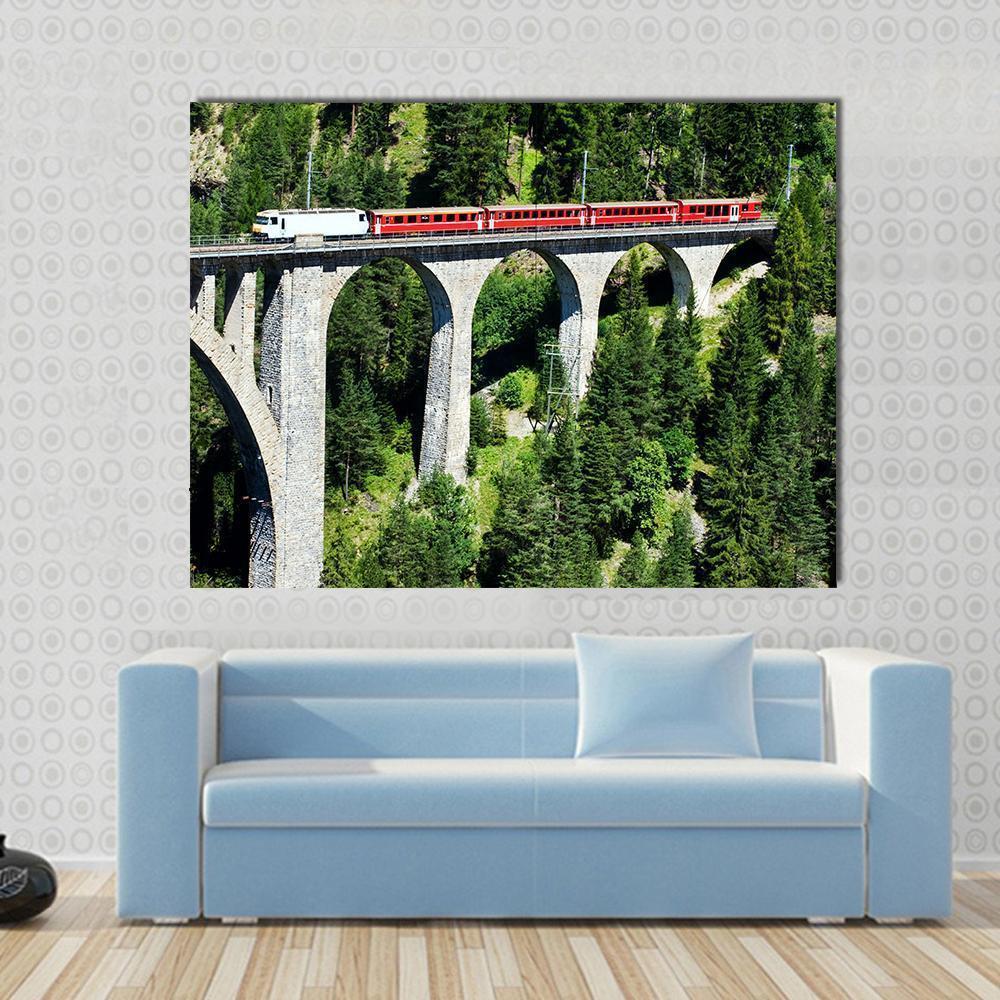 Swiss Train on Curved Stone Viaduct Canvas Wall Art in gray, red and green, single panel hung on a wall