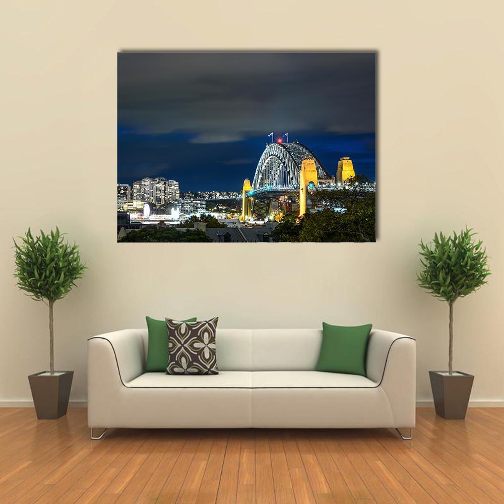 Sydney Harbour Bridge at Night Canvas Wall Art in black, yellow and blue, single panel hung on a wall