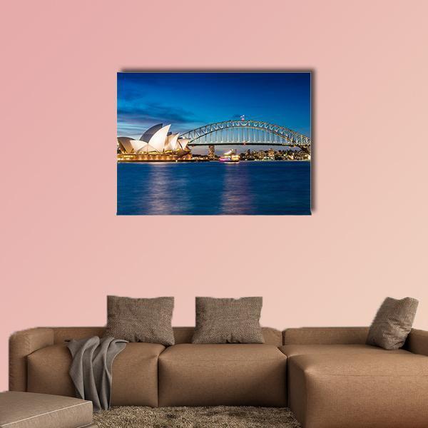 Sydney Opera House and Harbour Bridge at Night Canvas Wall Art in white, blue and navy, single panel hung on a wall