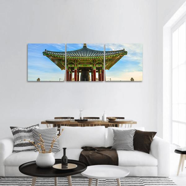 Korean Friendship Bell Pavilion Panoramic Canvas Wall Art in brown, green and blue, hung on a wall