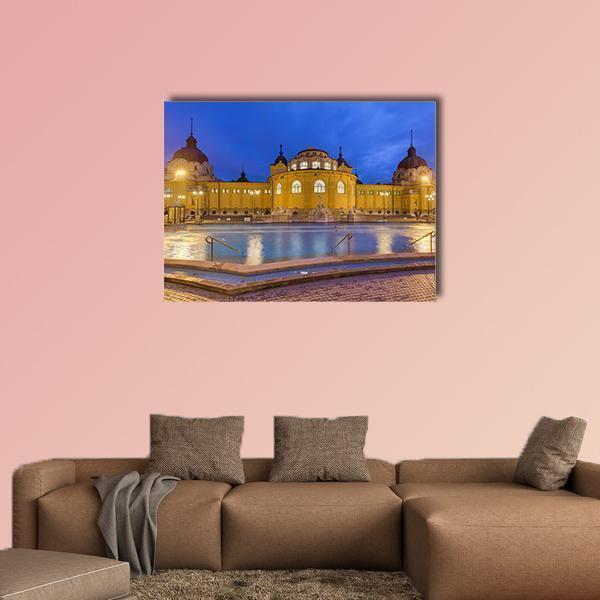 Szechnyi Thermal Bath in Budapest Canvas Wall Art in yellow and blue, single panel hung on a wall