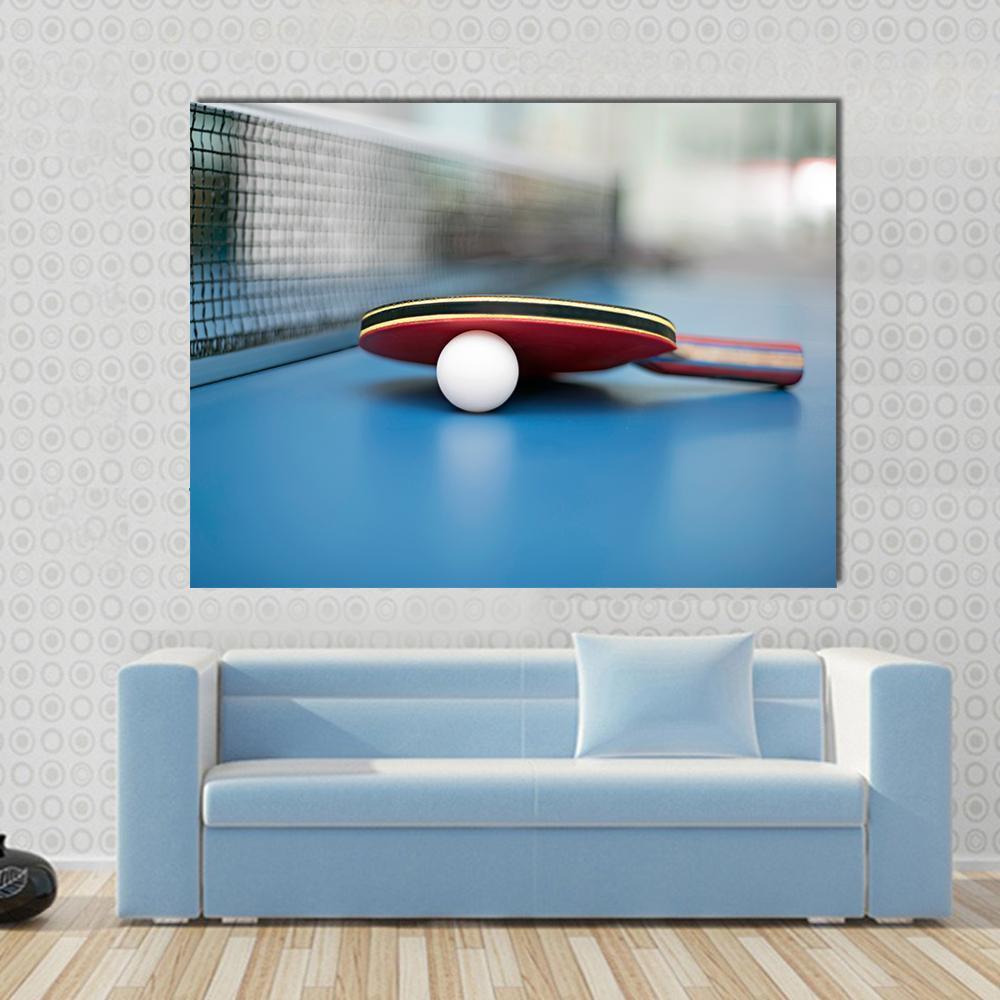 Table Tennis Ball and Bat Canvas Wall Art in white, red and blue, single panel hung on a wall