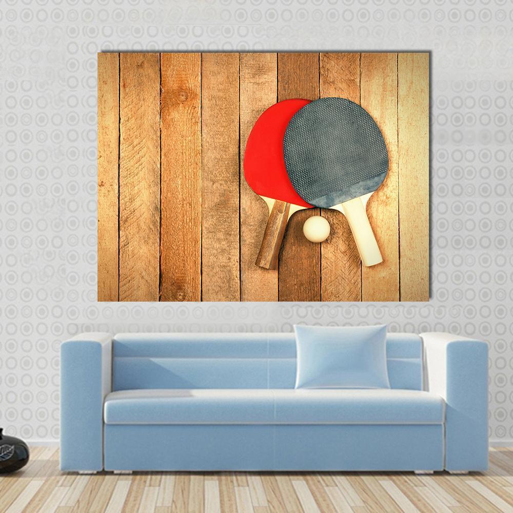 Table Tennis Paddles and Ball Canvas Wall Art in black, brown and red, single panel hung on a wall