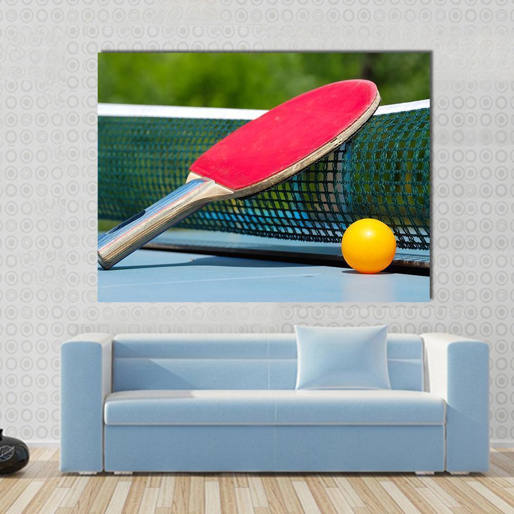 Table Tennis Racket and Ball on Net Canvas Wall Art in red, green and blue, single panel hung on a wall