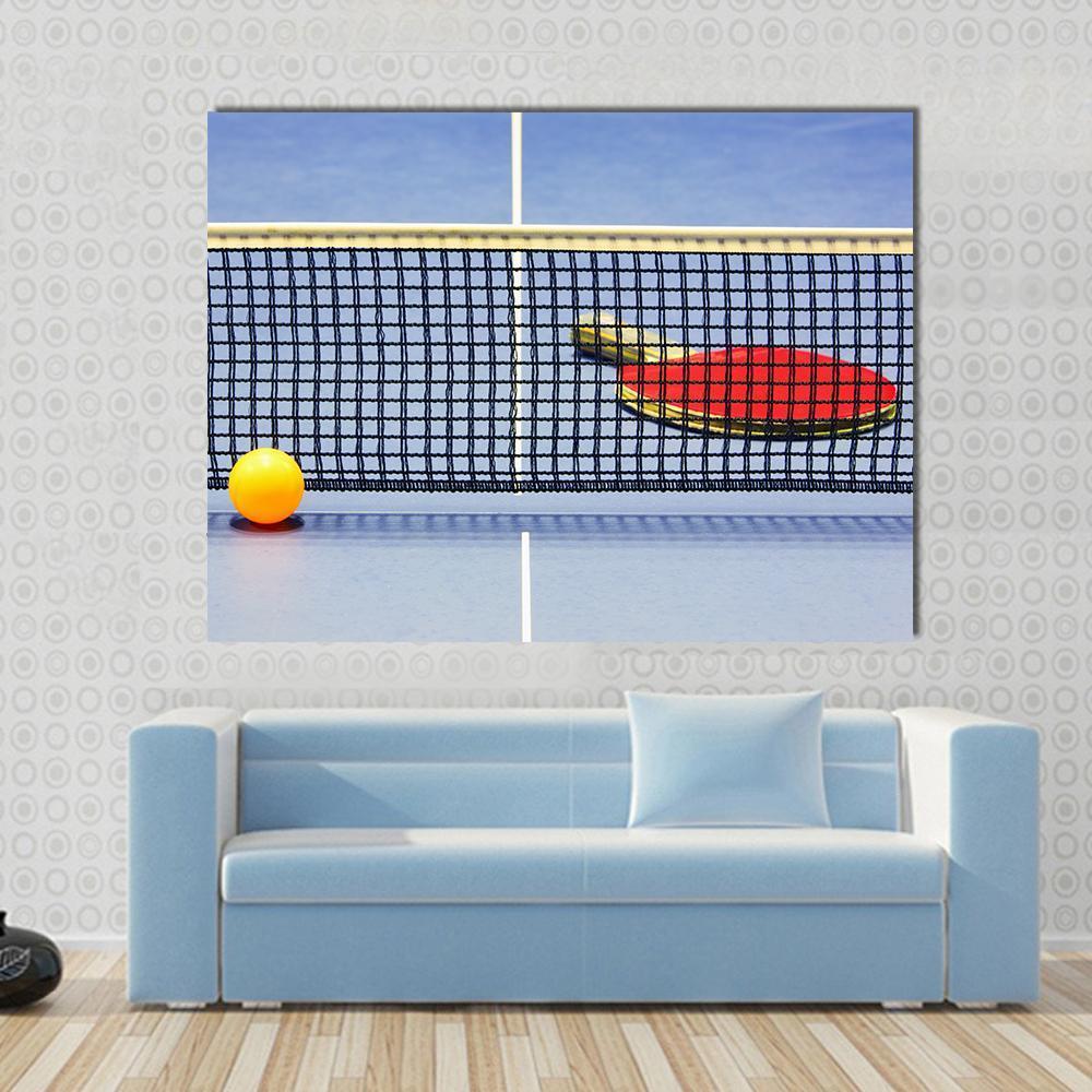 Table Tennis Racket and Ball Canvas Wall Art in black, red and blue, single panel hung on a wall