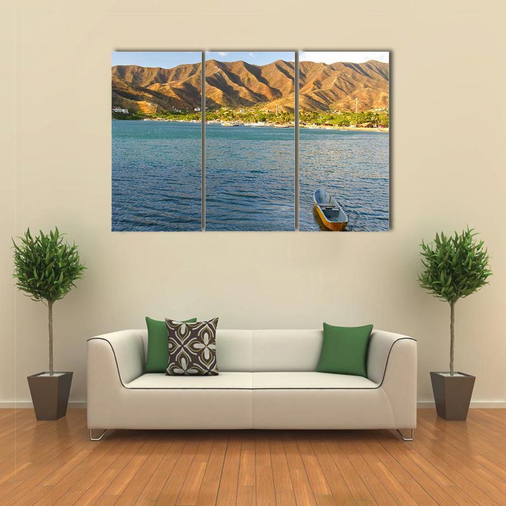 Taganga Bay Coastal Landscape with Yellow Rowboat Canvas Wall Art in brown, yellow and blue, 3 panel horizontal set hung on a wall