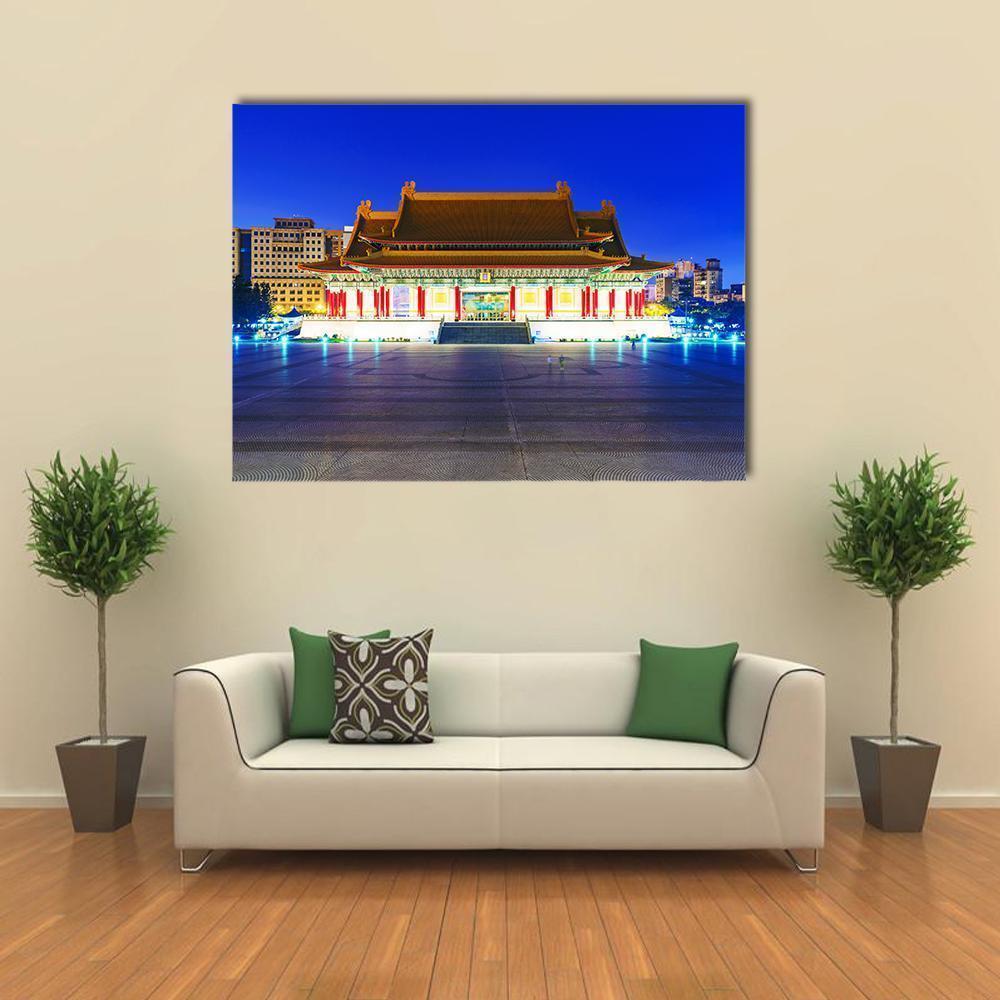 Illuminated East Asian Theater at Night Canvas Wall Art in gold, yellow and blue, single panel hung on a wall