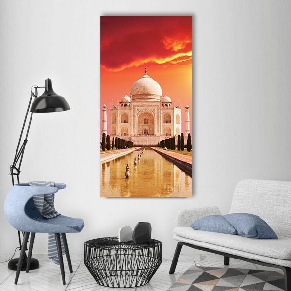 Taj Mahal Reflection at Sunset Vertical Canvas Wall Art in beige, red and orange, single vertical panel hung on a wall