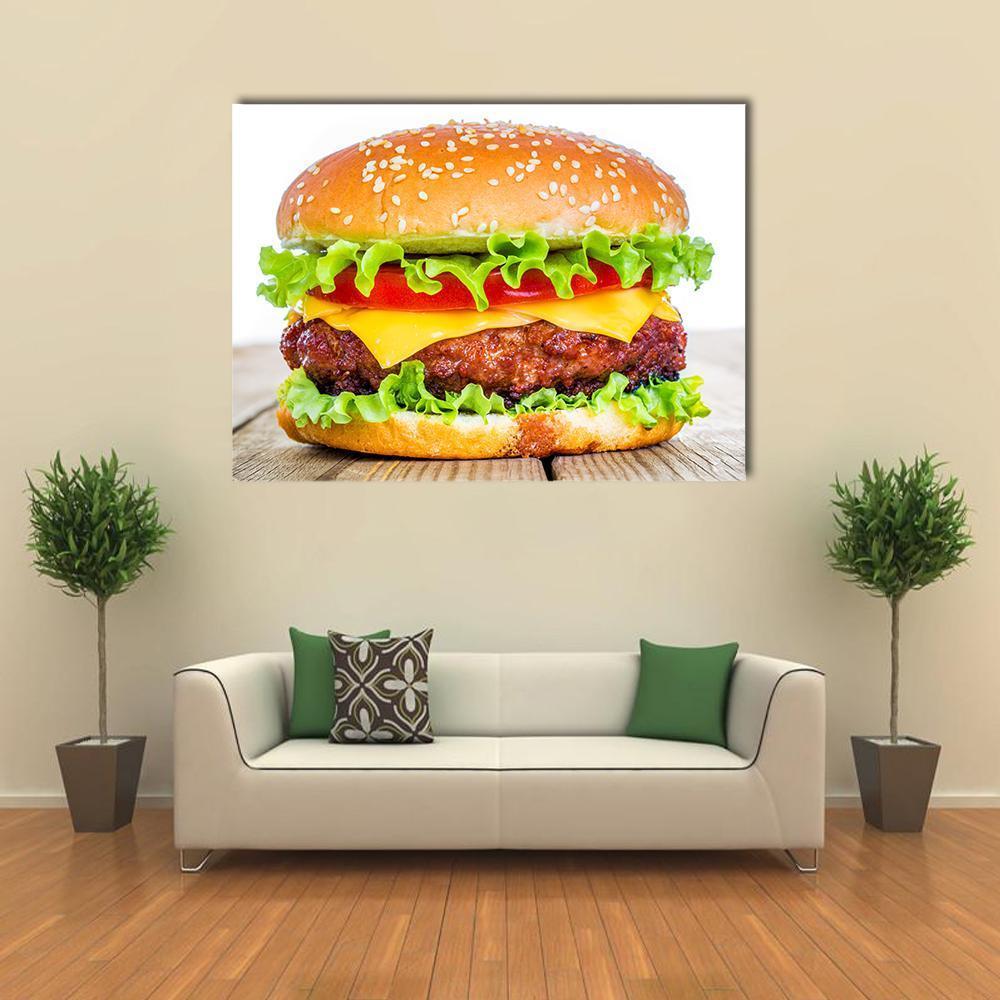 Cheeseburger Close-up Canvas Wall Art in brown, yellow and green, single panel hung on a wall