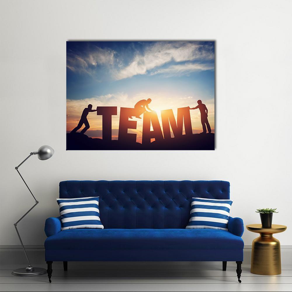 Team Lettering with Silhouetted Figures Canvas Wall Art in black, orange and blue, single panel hung on a wall