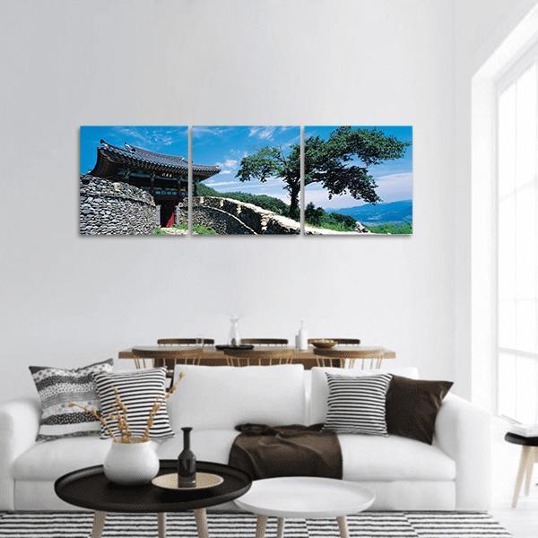 Korean Temple with Stone Fortress Panoramic Canvas Wall Art in gray, green and blue, hung on a wall