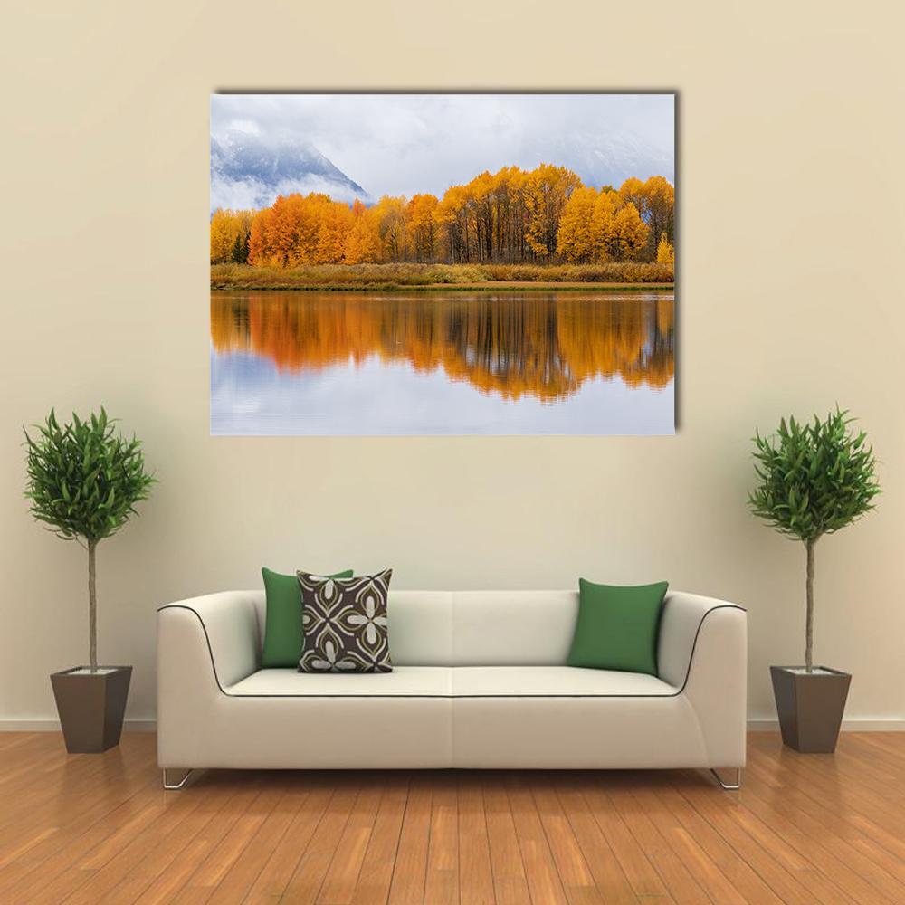 Autumn Mountain Lake Reflection Canvas Wall Art in orange, yellow and blue, single panel hung on a wall