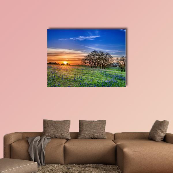 Bluebonnet Field at Sunset Canvas Wall Art in orange, green and blue, single panel hung on a wall