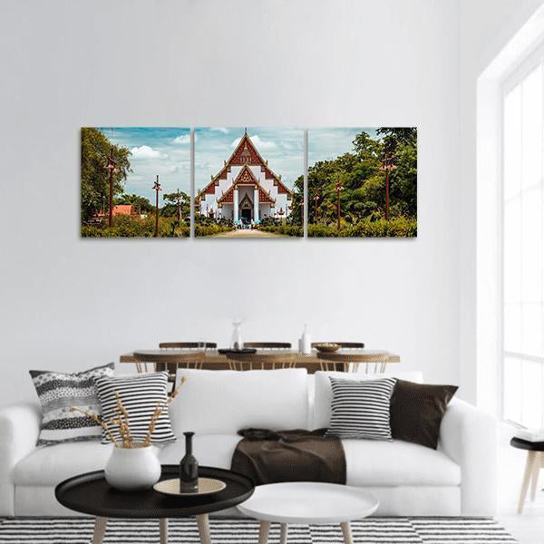 Ornate Thai Buddhist Temple Panoramic Canvas Wall Art in white, green and blue, hung on a wall