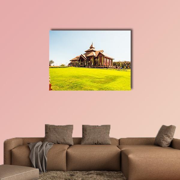 Prayodkhunpol Wiang Kalong Temple Canvas Wall Art in brown, green and blue, single panel hung on a wall